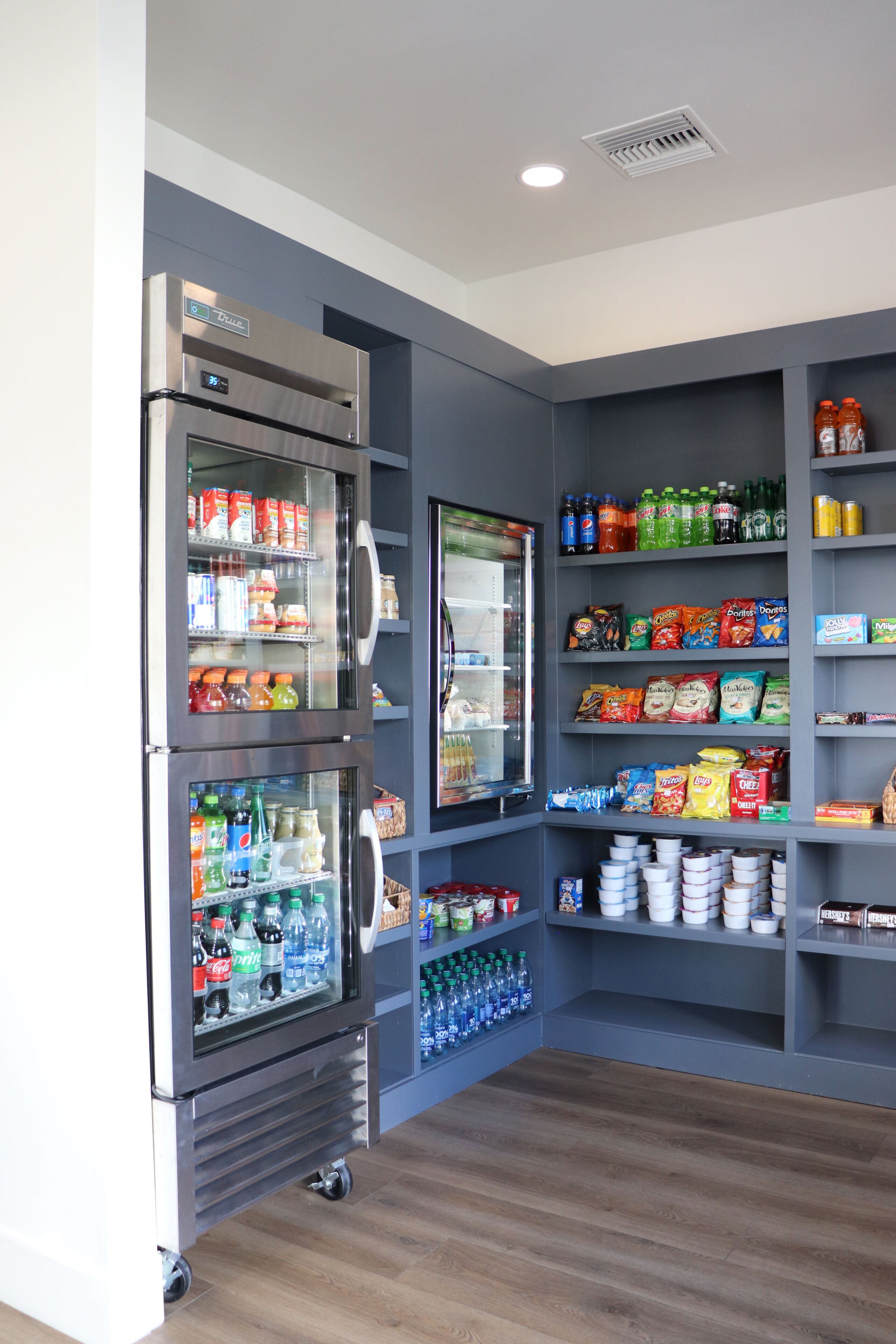 A vending area with multiple beverage dispensers and snack shelves.