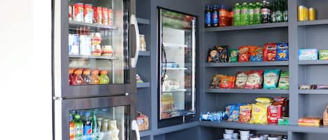 A vending area with multiple beverage dispensers and snack shelves.