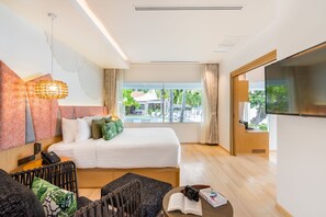 A hotel room with a bed, a TV, a desk, and a view of a pool. - La Vida Samui (Koh Samui)