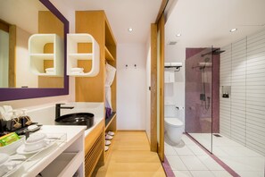 A modern bathroom with a vanity, mirror, shelves, and a shower area. - La Vida Samui (Koh Samui)