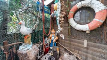 A rustic outdoor setting with a wooden structure, a rope swing, and a life preserver.
