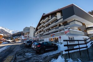 A multi-story hotel with a parking area in front. - App Savoleyres - Two Bedroom Apartment, Sleeps 6 (Riddes)