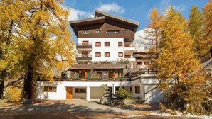 A multi-story hotel with a modern architectural design, featuring balconies and a ski lift visible in the background. - Matterhorn View Apartment in Breuil-Cervinia near Ski Area (Valtournenche)