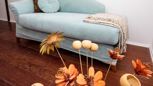 A light blue sofa with a throw blanket and decorative pillows against a white wall. - Adorable Holiday Home Located Near the Beach (Baska)