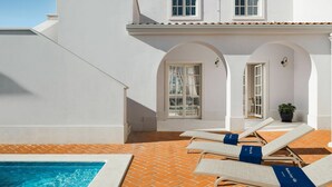 A pool area with lounge chairs and a tiled patio. - 4-bed Villa With Pool in Vabriga (Tar-Vabriga)