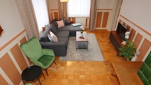 A living room with a sofa, chairs, a coffee table, and a TV. - Mountain Biker's Farmstay (Villingen-Schwenningen)