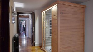 A hallway with a wooden wardrobe, a radiator, and a door leading to another room. - Spacious Villa in Liege (Spa)