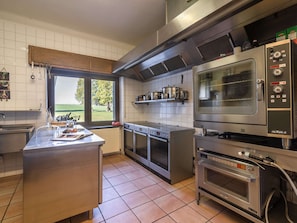 A modern kitchen with stainless steel appliances, a large window, and a view of the outdoors. - Gouvy Getaway Holiday Home (Gouvy)