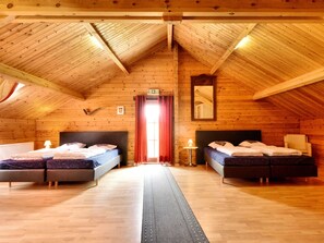 A log cabin room with two beds, a mirror, and a red curtain. - Splendid Chalet near Durbuy (Durbuy)