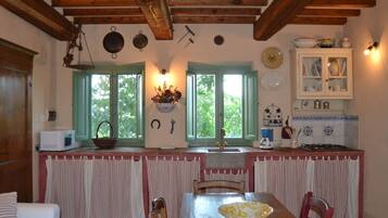 Cottage | Private kitchen | Highchair, cookware/dishes/utensils, dining tables