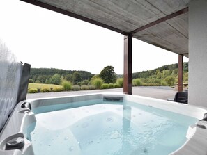 A hot tub under a covered area with a view of a forested landscape. - Classy Holiday Home in Martilly with Hot Tub (Herbeumont)
