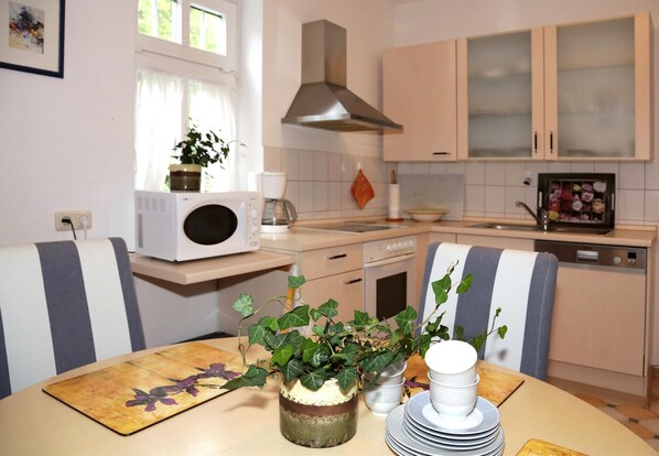 Enjoy meals in this well-equipped kitchen with a range, microwave, and dishwasher.