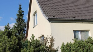 A house with a sloped roof, a chimney, and two windows. - Apartment in Kropelin With Terrace (Kroepelin)