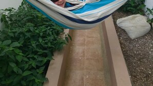 A narrow pathway with two hammocks strung between white walls, surrounded by greenery and a tiled floor. - Large private villa with a pool and jacuzzi, close to the beach (Playas Villamil)