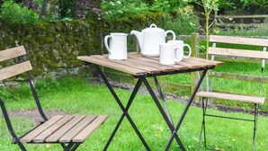 A wooden table with a white teapot, two white cups, and a white jug. - 1 bedroom accommodation in Bowes, near Barnard Castle (Bowes, near Barnard Castle)