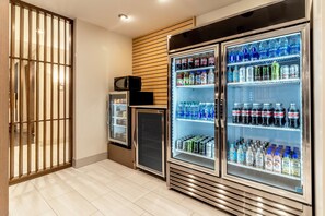 A kitchenette area with a microwave, refrigerator, and a small fridge. - Holiday Inn Express Milwaukee West Allis by IHG (Milwaukee)