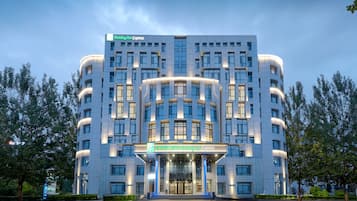 Stunning hotel facade with a central entrance and curved balconies.