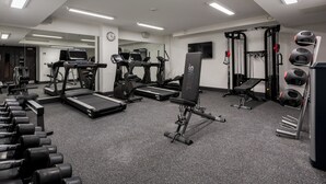 A gym with treadmills, weight machines, and free weights. - voco Edinburgh-Haymarket by IHG (Edinburgh)