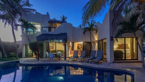 A modern resort with a swimming pool, outdoor seating, and a well-lit interior. - Beachfront, Private Pool, close to Downtown San Jose (San Jose del Cabo)