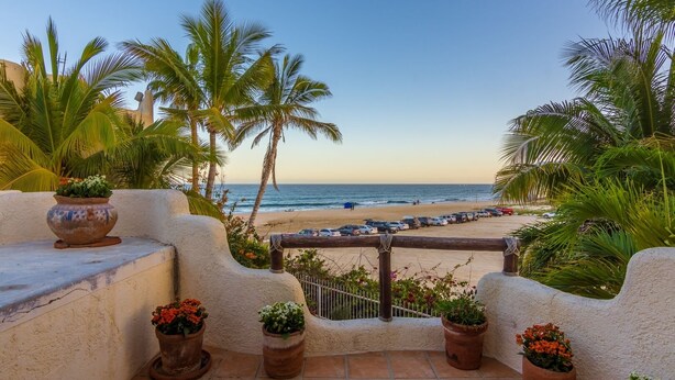 A terrace with a view of the beach, palm trees, and potted plants. - Beachfront, Private Pool, close to Downtown San Jose (San Jose del Cabo)