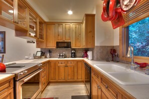 Enjoy cooking and cleaning in this kitchen with a sink, stove, and dishwasher.
