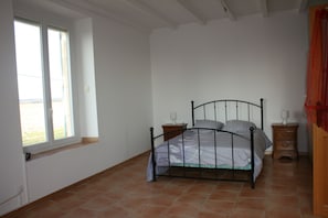 Cozy retreat with a single bed, two nightstands, and a window with a view.