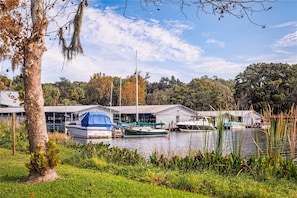 Guests can enjoy serene lakeside views from the marina, with a boat docked nearby.