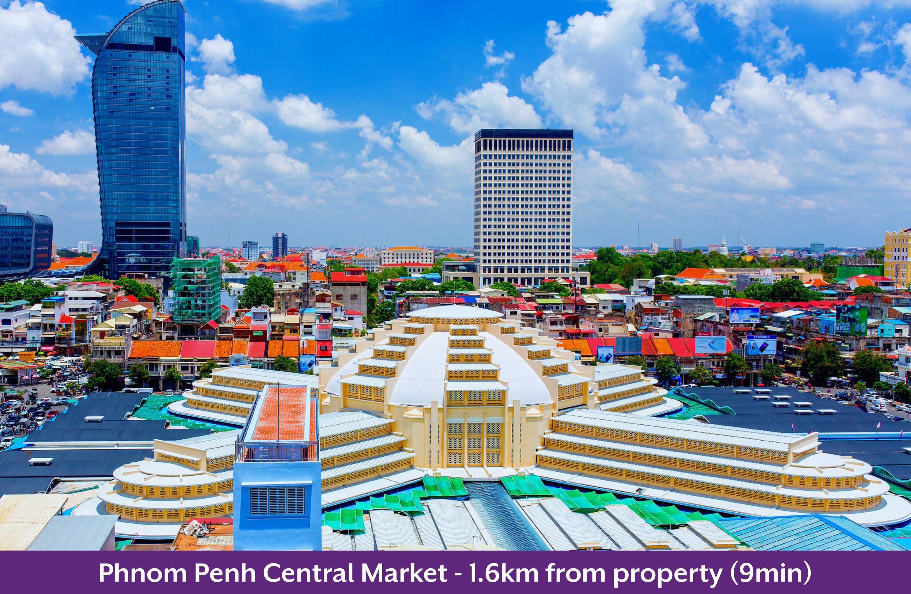 A large, circular market with a central building and surrounding structures, surrounded by a mix of modern and traditional buildings.