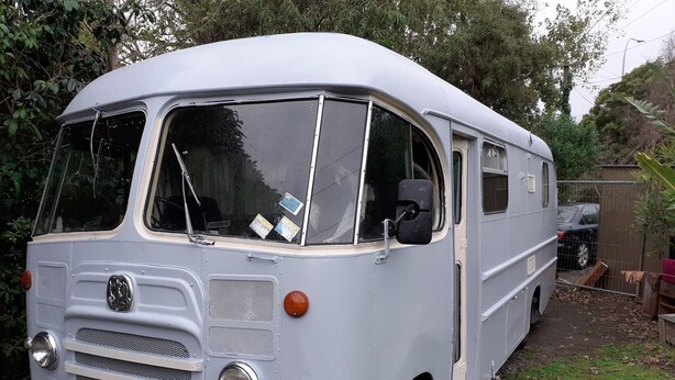 A vintage white van parked in a yard with a license plate. - retro  housebus love (Waikanae)