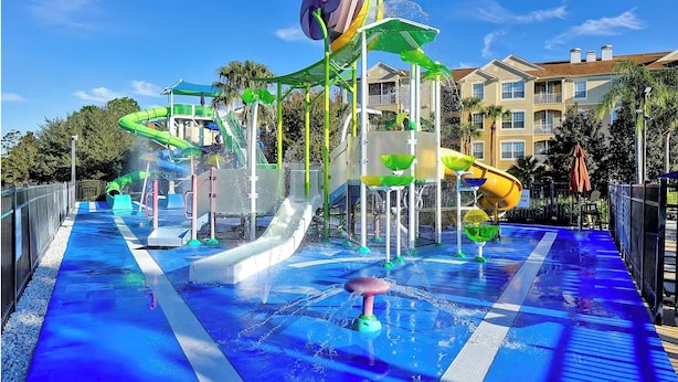 A water park with multiple slides and water features, surrounded by residential buildings.