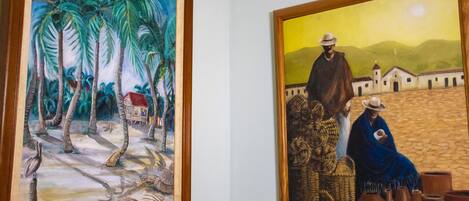 Two framed paintings on a wall.
