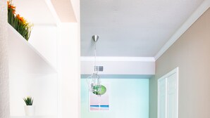 A modern interior with a dining area, wooden flooring, and a white wall with a small plant. - COMFY COZY MED CENTER HOME (Houston)