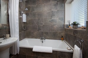 Combined shower/tub, hair dryer, towels, soap