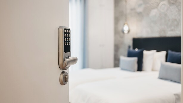 A modern hotel room with a bed, a wall-mounted control panel, and a nightstand. - &Tales Suites - Óbidos (Obidos)