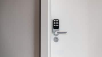 A modern door with a keypad lock and a keyhole.