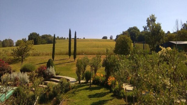 A rural landscape with a clear sky, a field, and a small building. - Attractive Mansion With Pool (Cortona)