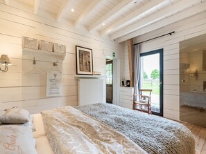 A bedroom with a bed, a chair, a radiator, and a window with a view of the outdoors. - Beautiful Farmhouse in Pittem With Garden (Pittem)