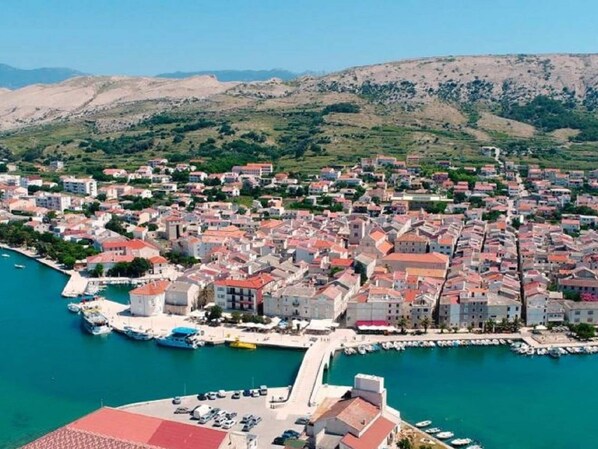 A coastal town with a marina, buildings with red roofs, and hills in the background. - Apartment in Mandre Near the Sea (Kolan)