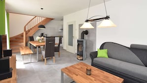 A modern living room with a sofa, coffee table, and dining area. - Holiday Home in Damshagen With Terrace (Damshagen)