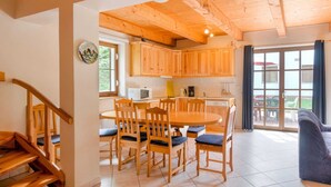 A wooden interior with a dining area, kitchen, and a staircase. - Holiday Home With a Convenient Location in the Giant Mountains for Summer & Winter (Rudník)
