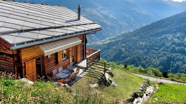A wooden cabin with a sloped roof, a balcony, and a view of a valley and mountains. - Chalet in Les Collons Near Ski Lift (Vex)