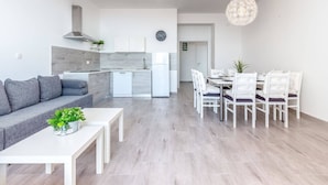 A modern apartment with a living area, kitchen, and dining space. - Villa in Dramalj With Swimming Pool (Crikvenica)