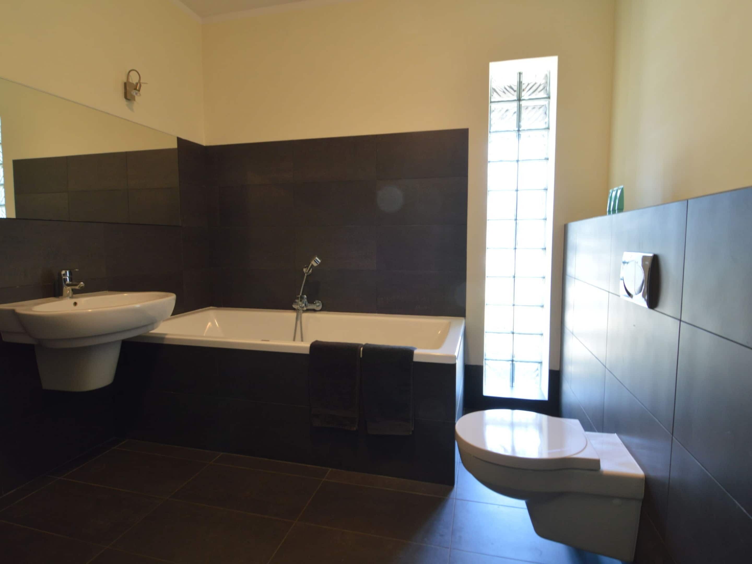 A bathroom with a sink, bathtub, and toilet.