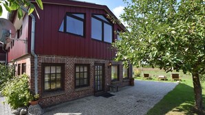 Ein zweistöckiges Gebäude mit roter Fassade und Ziegelverzierungen.