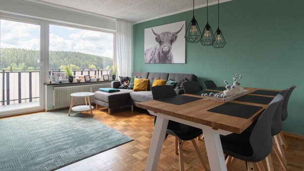 A modern living room with a dining area, large windows, and a view of the outdoors. - Tranquil Apartment in Marktleuthen near River & Forest (Marktleuthen)