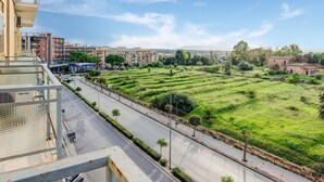 A residential area with terraced fields, a road, and modern buildings.
