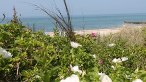 Een strand met een zandstrand en helder uitzicht op de oceaan.