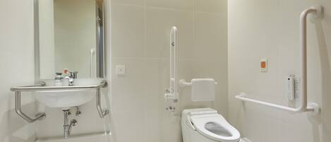 A modern bathroom with a white sink, toilet, and shower.