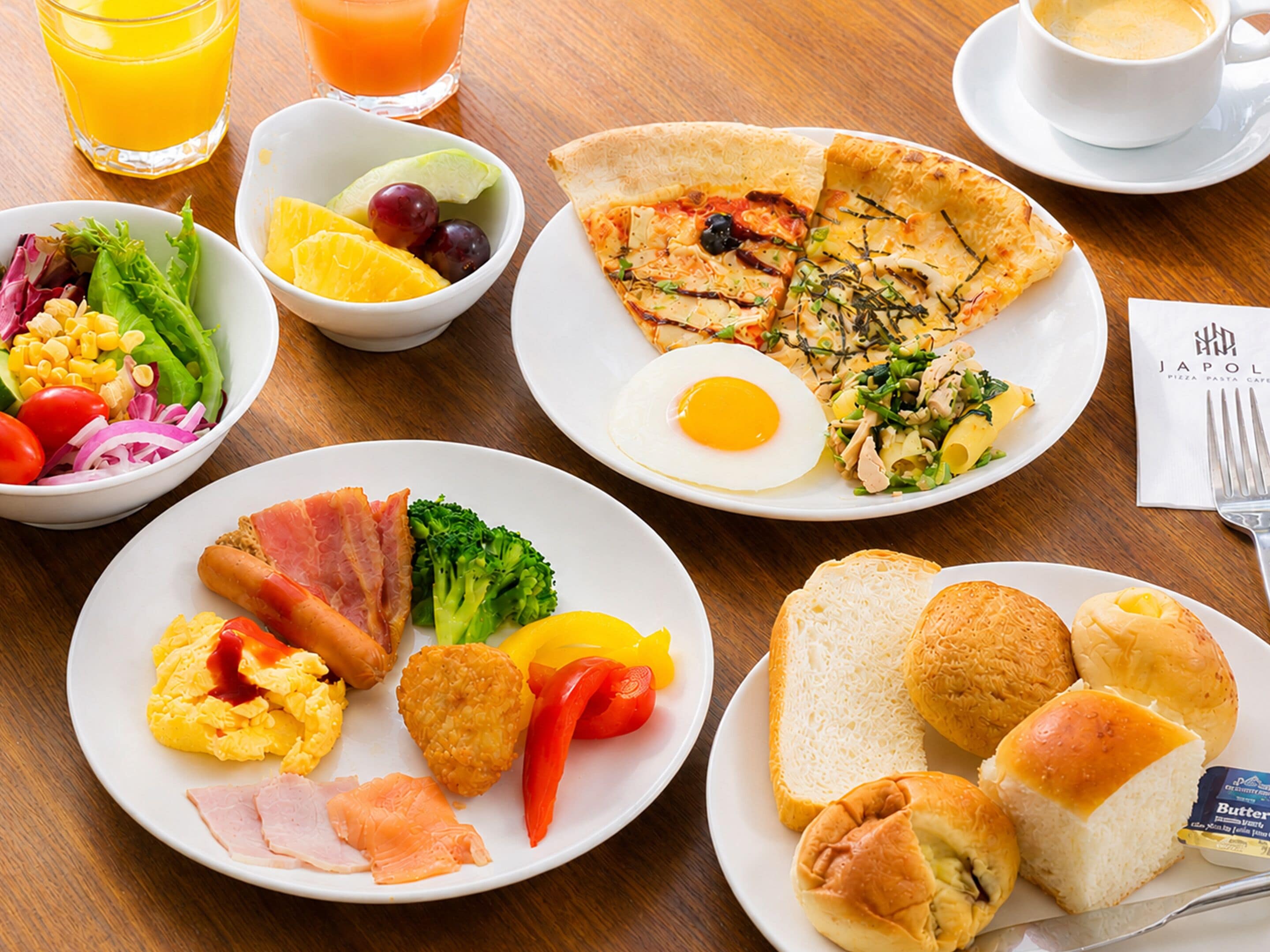 A breakfast buffet with various dishes including eggs, ham, toast, and a salad.