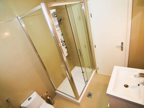 A modern bathroom with a glass-enclosed shower, a white sink, and a toilet. - Modish Apartment in Murter with Hot Tub (Murter-Kornati)